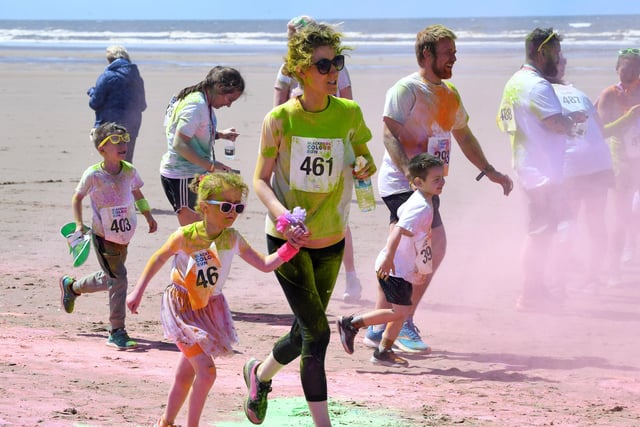 A helping hand from mum and dad for youngsters taking in the Blackpool Colour Run