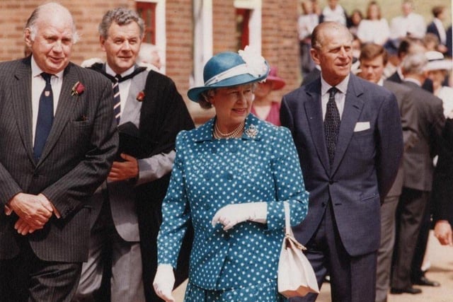 Prince Philip and Queen Elizabeth II walk the school grounds at Rossall in 1994