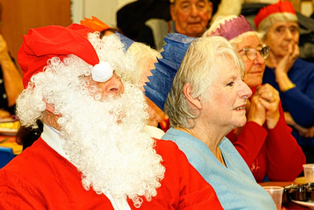 Guests- including Santa - enjoy the singing of Manor Beach Primary School pupils during the annual Christmas lunch