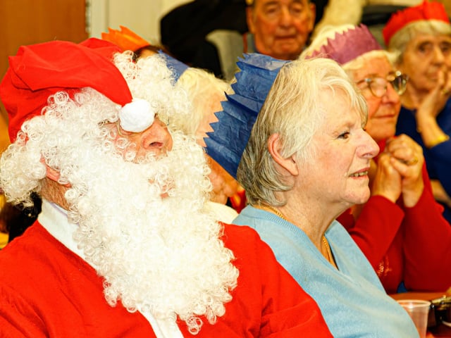 Guests- including Santa - enjoy the singing of Manor Beach Primary School pupils during the annual Christmas lunch