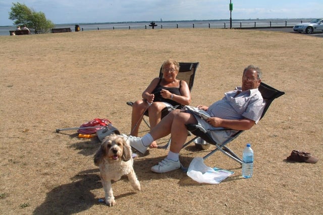 Believe it or not, this is Lytham Green! Pictured are Mr and Mrs Bloomfield and their doggy pal on the parched grass during a particularly dry patch and hot weather