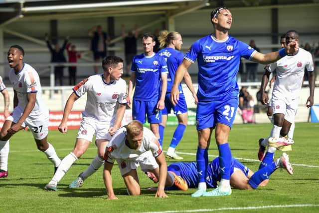 Harry Davis (on the floor) scores AFC Fylde's second goal against Chesterfield Picture: Steve McLellan