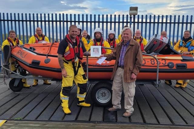 Martin Brook presents his cheque to Fleetwood RNLI