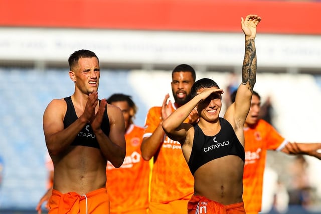Jerry Yates and Ian Poveda celebrate with the Blackpool fans at the full-time whistle