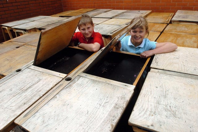 Remember the wooden desks with ink wells, Year 6 pupils, David Rushe, 11 and Amy Ellis, 11 show them off before they were donated to charity
