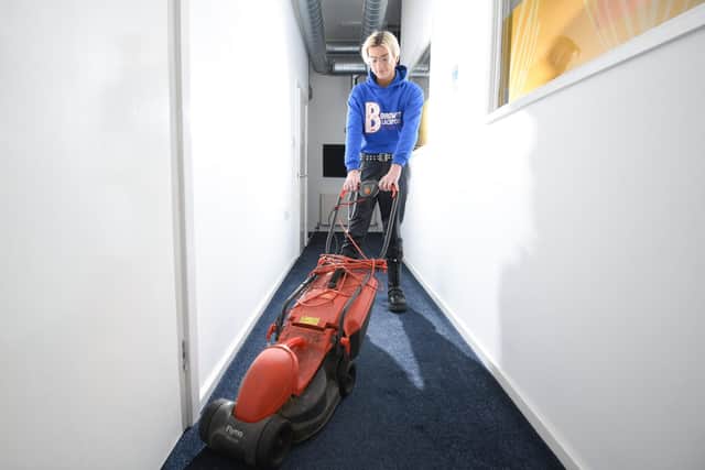 Danny Gawthorpe is pictured with a lawnmower - one of the household items available to loan from Borrow It Blackpool.