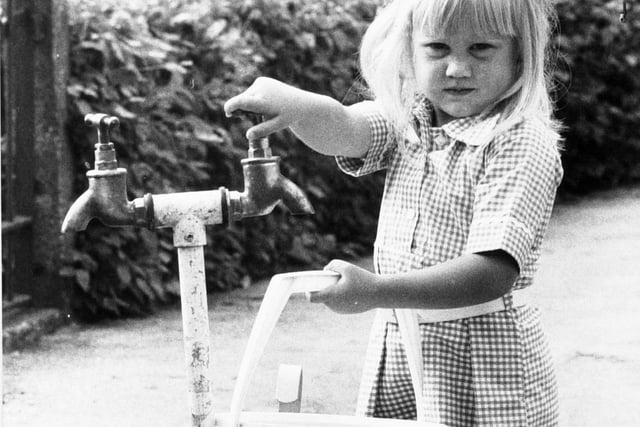 A child collects water from a stand pipe when the drought of 1976 kicked in