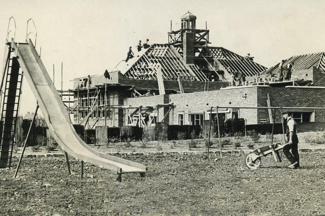 Work proceeding on the new Library and Maternity and Child welfare Clinic at the corner of Devonshire Road and Bispham Road, Bispham. The children's playground on Devonshire Road is in the foreground, 1937