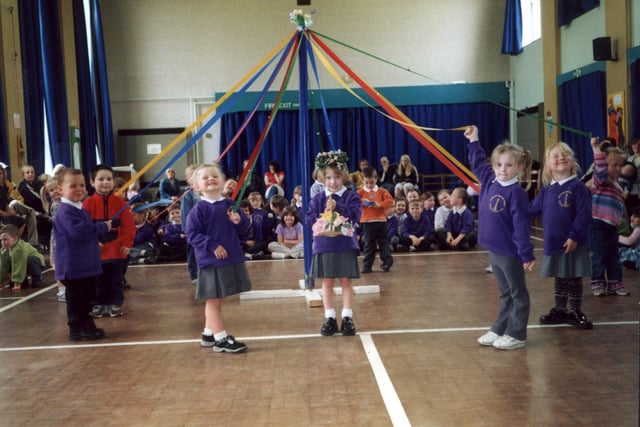 Children from Boundary Primary School nursery dancing round the maypole in 2002