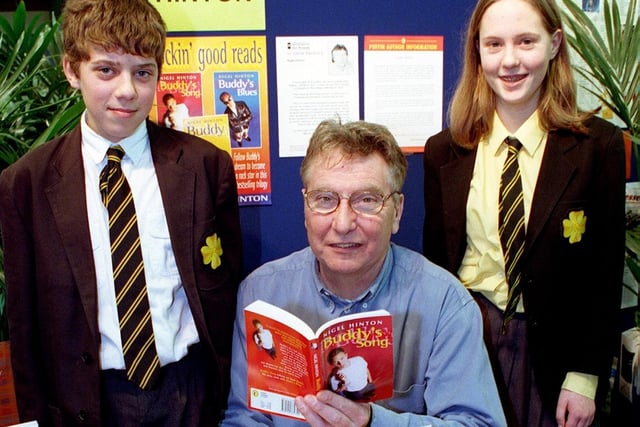 Author Nigel Hinton, creator of Buddy and Buddy's Song, visited Lytham St Annes High School to talk to pupils about writing. Pic shows pupils Sean Hewson (13) and 14 year-old Gemma Dooney getting their books signed by the author, 1999