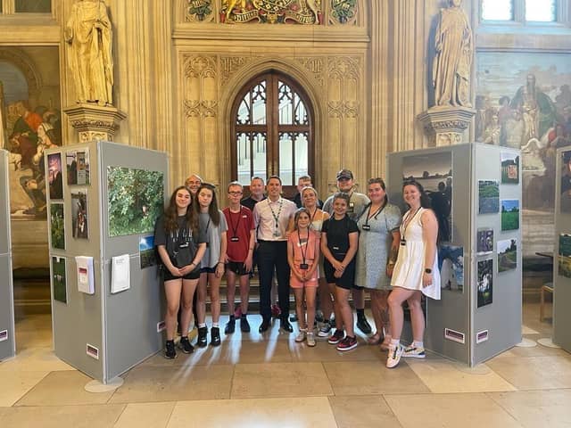 Members of Blackpool Boys and Girls Club with MP Scott Benton and their photographic exhibition at the Houses of Parliament