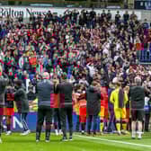 Fleetwood celebrate their League One survival with supporters at Bolton but it was a close run thing Picture: SAM FIELDING / PRiME MEDIA IMAGES