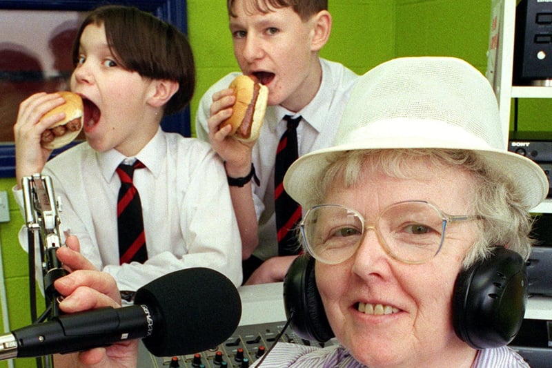 Unit Manager Ann Fiddies announces the day's menu on Radio Warbreck, while Station Manager Chris Houghton (right) and DJ Alex Hutchinson tuck into their sausage butties at Warbreck High School