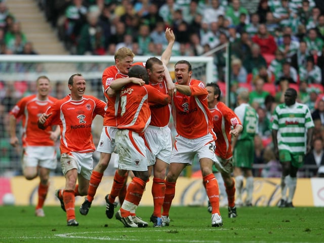 The Blackpool squad celebrate.