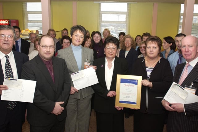 Department of Works and Pensions, Norcross, cheque presentations. Front L-R Chris Noad of Brian House, John Stott of DWP, Linda Brislin of the Air Ambulance, Angela Hellenburgh of the DWP, Ros Jackson of the DWP  and David Fielding of Cancer Research UK
