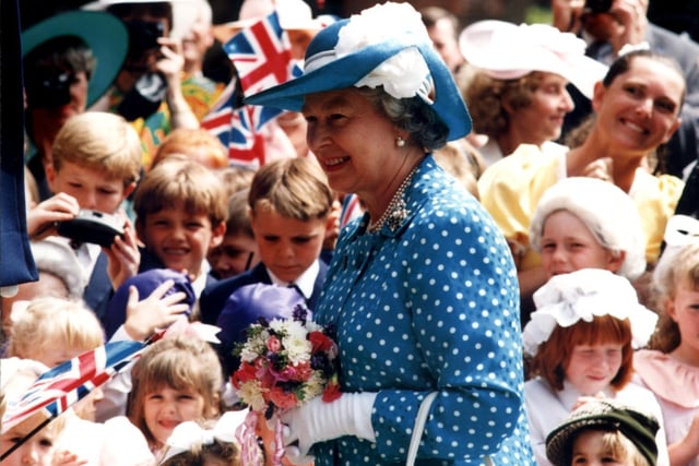 The Queen is greeted by excited children at Rossall School in 1994