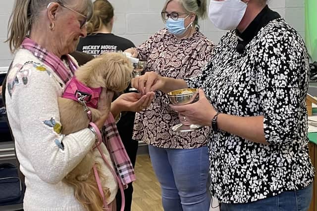The Rev Linda Thomkinson (right)  during Holy Communion at the Freedom Church in Mereside,  where pets are allowed to accompany parishioners. Later this month the church will play host to a pet blessing ceremony