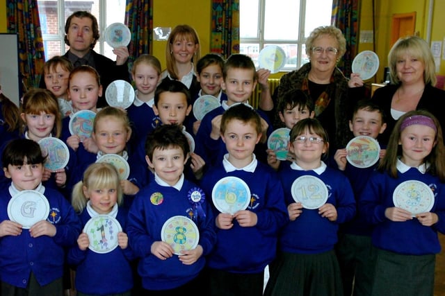 Pupils Holy Family Catholic Primary School who took part in a Blackpool Civic Trust competition to design signs for the new heritage trail at Stanley Park. Adults from left: Tim Riley (Blackpool Council parks development officer), Helen Moreton (headteacher), Elaine Smith (Blackpool Civic Trust chairman), and Salli Brown (Granthams Signs)