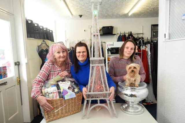 Chrissie Meryem, Hanna Statham and Lucy Wood with dog Cookie are auctioning items including a replica tower to raise money for animals in Ukraine.