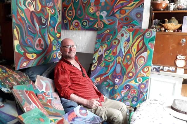 Phil Walters with some of the paintings at his home