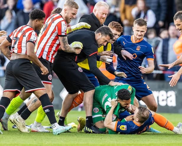 Lavery was wrestled to the ground by Blades goalkeeper Wes Foderingham