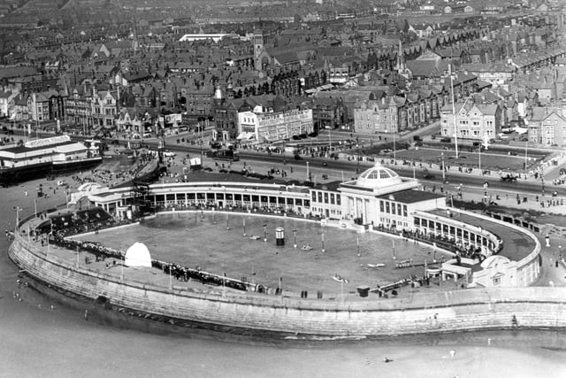 South Shore Open Air Pool seen during it's heyday, with a backdrop of the South Shore area of Blackpool. The pool was opened in the summer of 1924 but was demolished in 1984 to make way for The Sandcastle which when it opened in 1986, was the biggest single new development in Blackpool since the 1930s