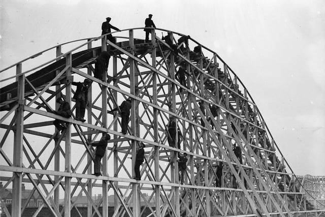 Men at work on the girders of a new switchback along the South Shore at Blackpool in readiness for the Easter holiday crowds