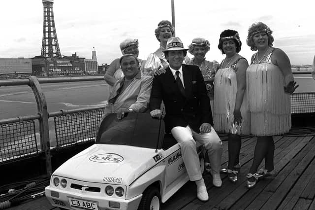Terry Wogan, Les Dawson and the Roly Polys pose on a miniature car to promote a visit to the North Pier, Blackpool