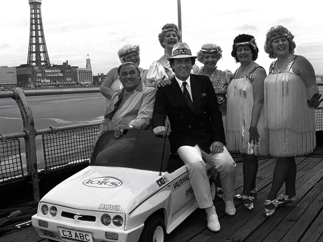 Terry Wogan, Les Dawson and the Roly Polys pose on a miniature car to promote a visit to the North Pier, Blackpool