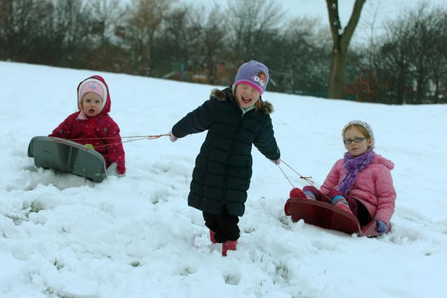 Grace, Hannah and Ellie Singleton playing in the snow in Clifton, near Preston