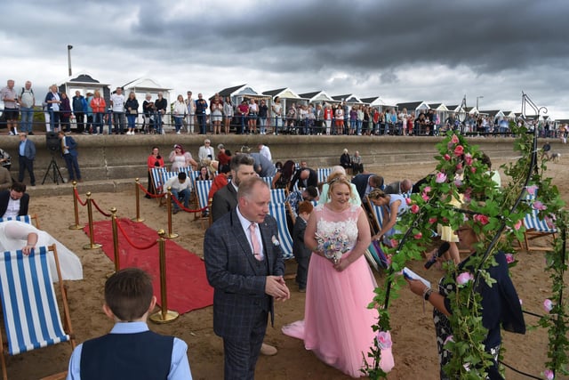Crowds look on as Louise Wiltshire and Shaun McGilloway are married on St Annes beach. Picture: Neil Cross.