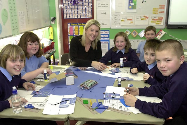 Following a fire in 2003 which devastated their school, pupils of Class 5M make 2004 calendars with their teacher Michelle McFarlane at their temporary site on Grange Park