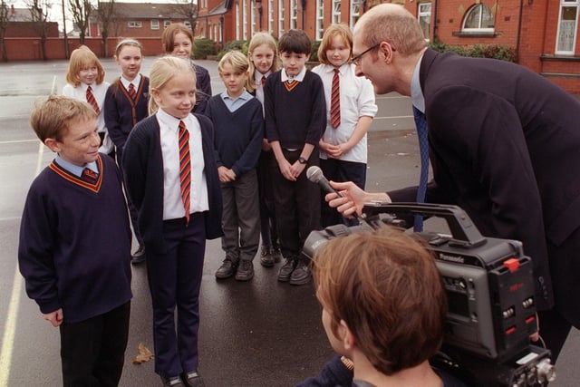 Children at Waterloo Primary School being interviewed for a Millennium film. Carl Thompson and Leanne Unsworth with Blackpool Council PR Officer Craig Noonan. The cameraman is University of Central Lancashire student Iain Waddington, 1999