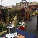 A wreath is laid in memory of the three police officers who drowned off North Shore in January 1983. Pictures: Neil Cross.