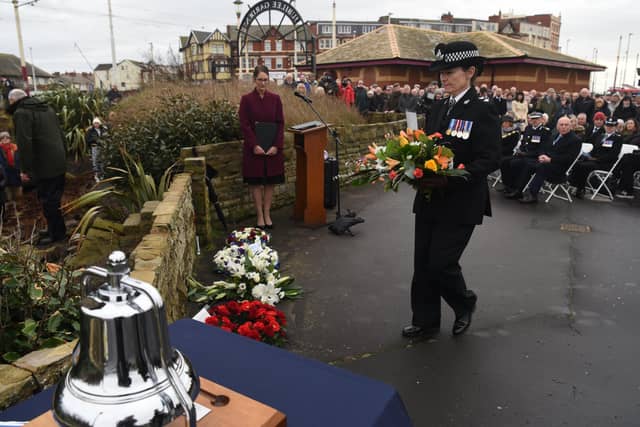 A wreath is laid in memory of the three police officers who drowned off North Shore in January 1983. Pictures: Neil Cross.