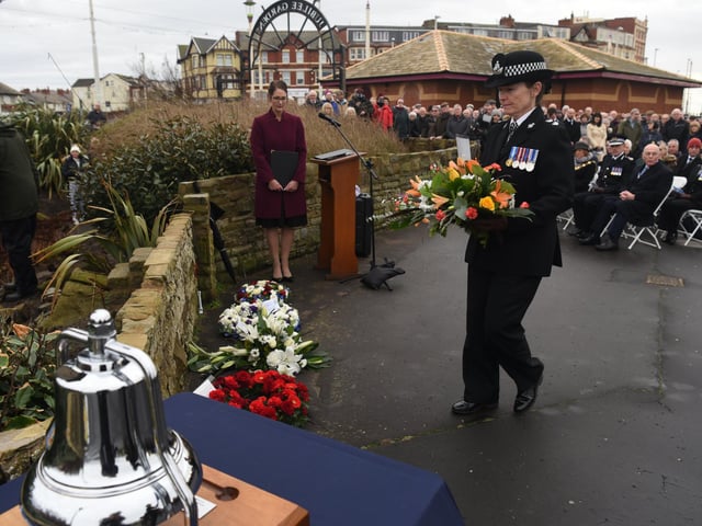 A wreath is laid in memory of the three police officers who drowned off North Shore in January 1983. Pictures: Neil Cross.