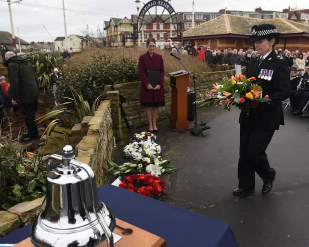 A wreath is laid in memory of the three police officers who drowned off North Shore in January 1983. Pictures: Neil Cross.
