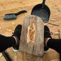 Vicki Lowe at work carving the tree stump found in the sea near her home