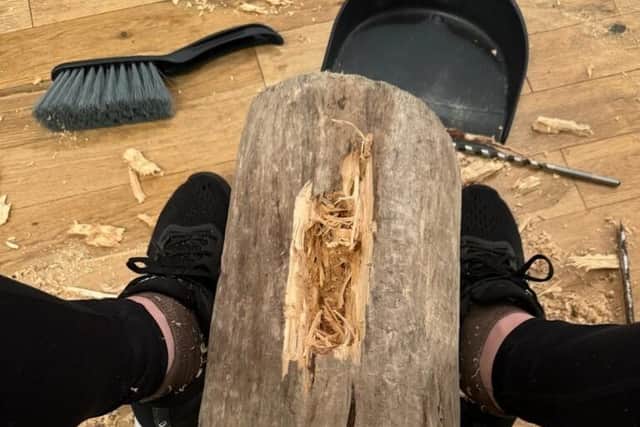 Vicki Lowe at work carving the tree stump found in the sea near her home