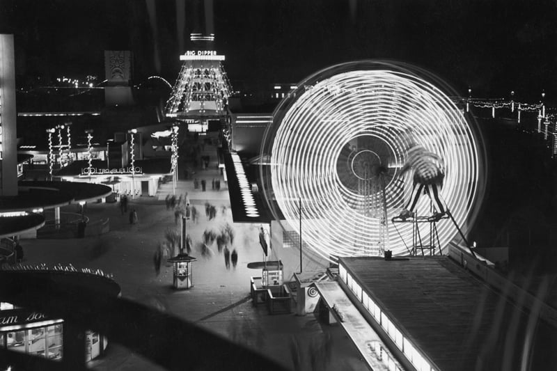 Illuminated rides at The Pleasure Beach in Blackpool, including the twin Ferris Wheel and the Big Dipper, 10th September 1955
