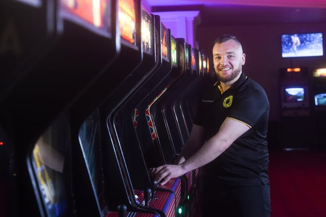 Manager Josh Derbyshire showing off one of the classic arcade games.