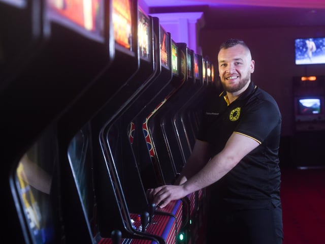 Manager Josh Derbyshire showing off one of the classic arcade games.