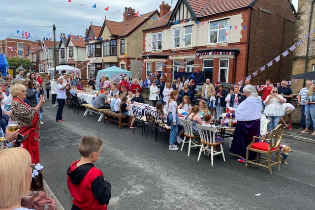 Residents gather around the huge table on Galloway Road in Fleetwood during the street  party for the Queen's Platinum Jubilee