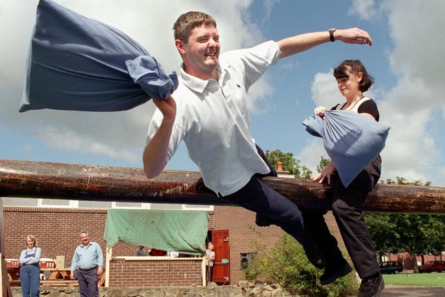 Family Fun Day at Kirkham Prison Officers Club, in aid of Chernobyl children. Alan Mason gets a bashing from Tracey Hartshorne, during their pillow fight on the greasy pole in 1998