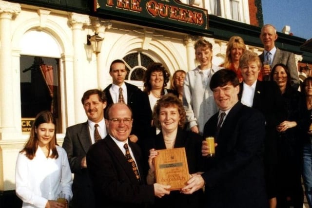 Whitebread Bowland Inns' operations manager, Mark Wilde is seen presenting Queens Hotel licensees Elaine and John Lomas and their team of staff of staff with the Team Hospitality award, 1997