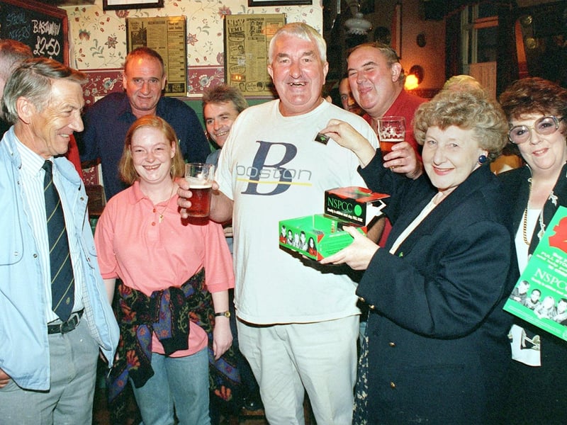 Wheatsheaf party night, 1999. Ian Thompson (centre) gets a badge from NSPCC local branch chairman June Duerden