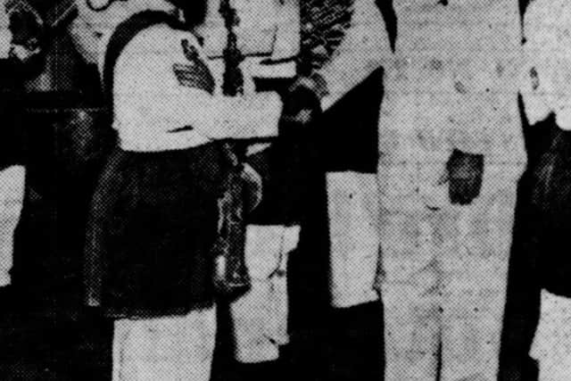 Brig Denaro CBE DSO bids farewell to a Malay Regiment bandsman at Kuala Lumpur Station 1958.
