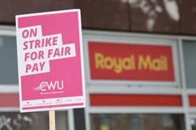 A sign held by a postal worker from the Communication Workers Union (CWU) on the picket line at a Royal Mail Delivery Office.Picture by James Manning/PA Wire