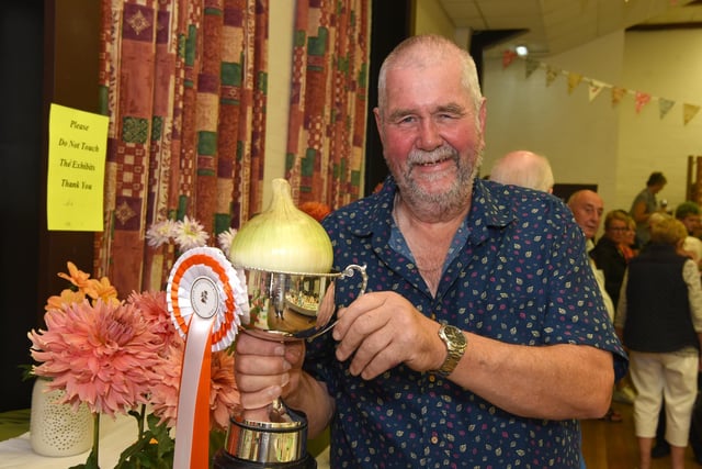 Chris Hankinson celebrates winning the prize for heaviest onion at Freckleton Horticultural Show. Picture: Neil Cross.