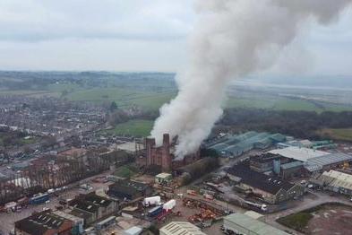 Smoke billows out of a building on fire in Lancaster.
